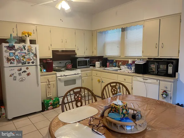 a kitchen with a refrigerator and a stove