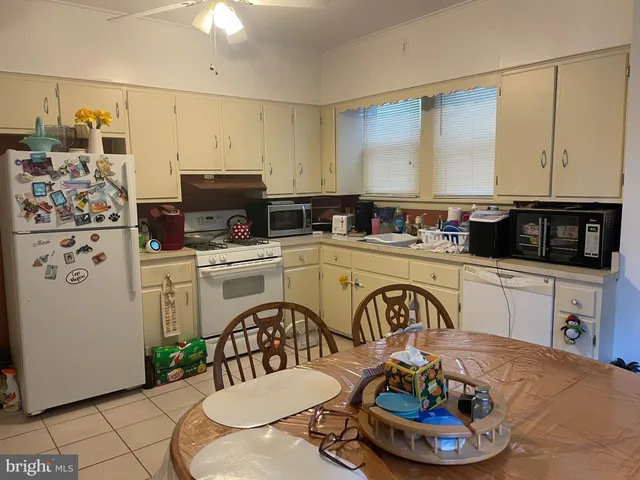 a kitchen with a refrigerator and a stove