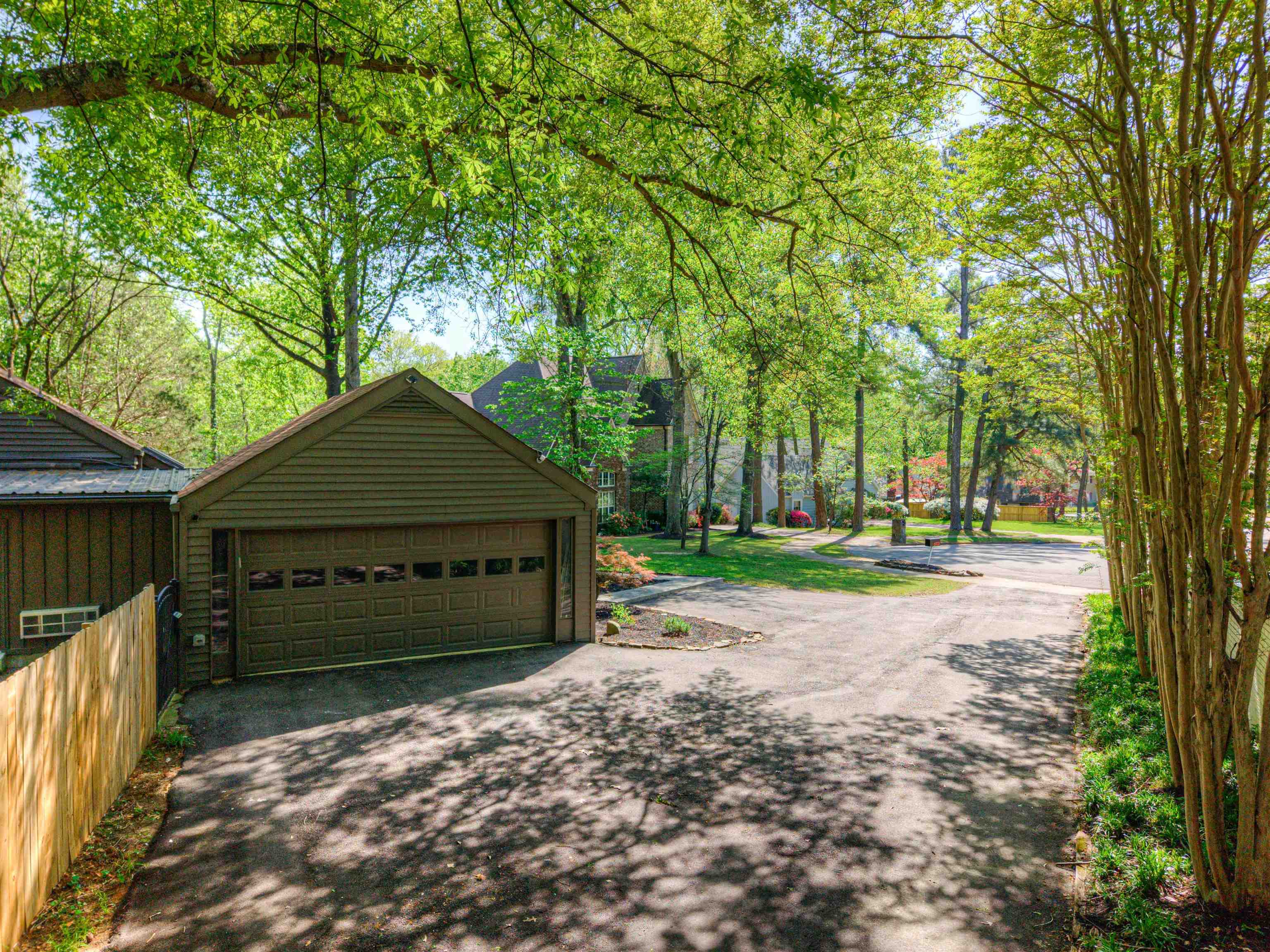 6921 Tangleberry Cove Memphis, TN 38119 - Photo 30 of 39 a front view of a house with a garden and trees