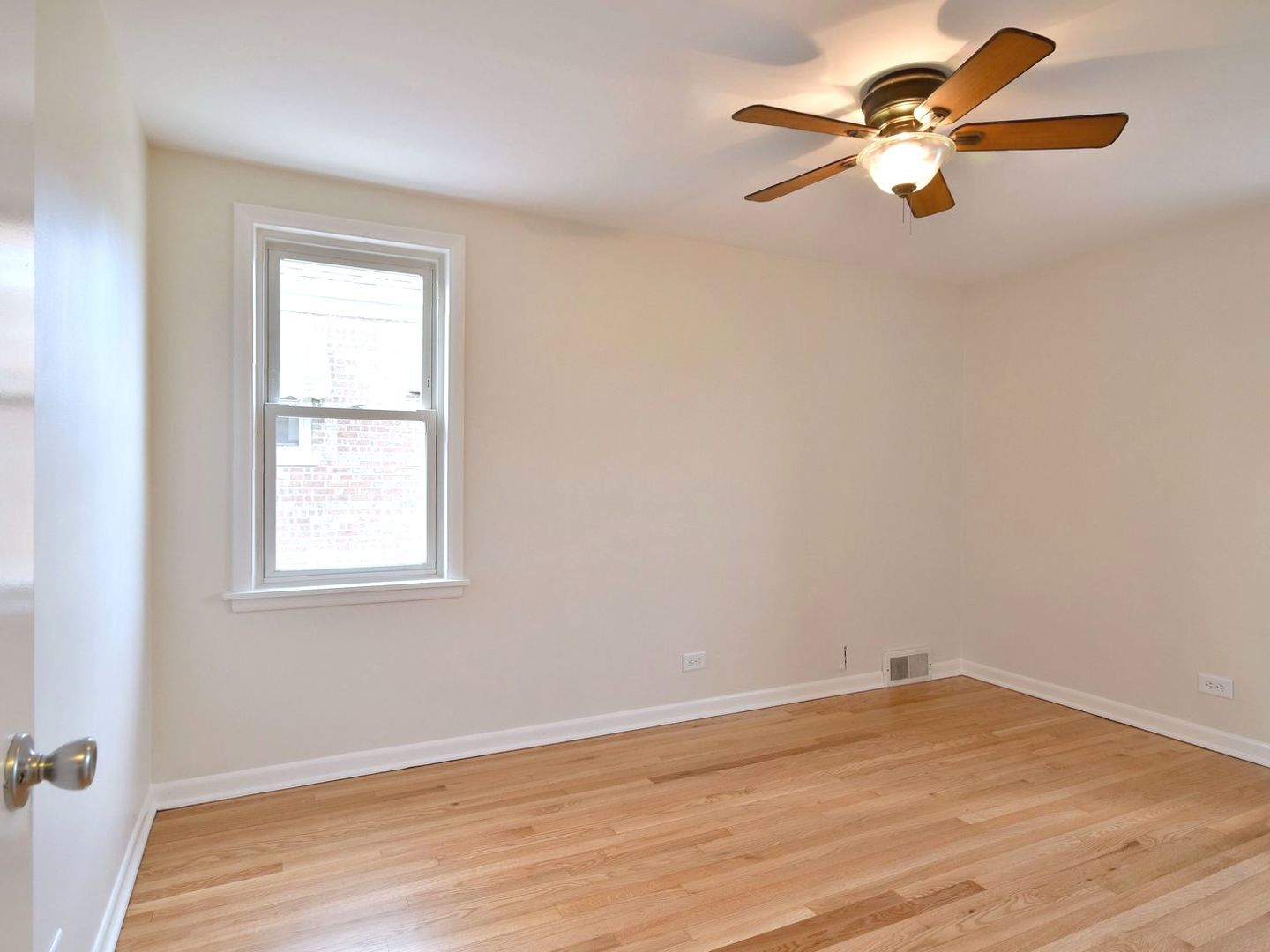 5220 South Rutherford Avenue Chicago, IL 60638 - Photo 11 of 18 an empty room with wooden floor fan and windows