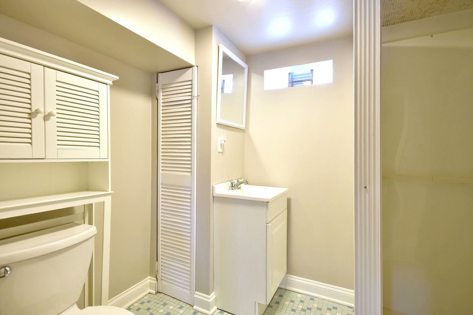 5220 South Rutherford Avenue Chicago, IL 60638 - Photo 17 of 18 a bathroom with a sink and a mirror