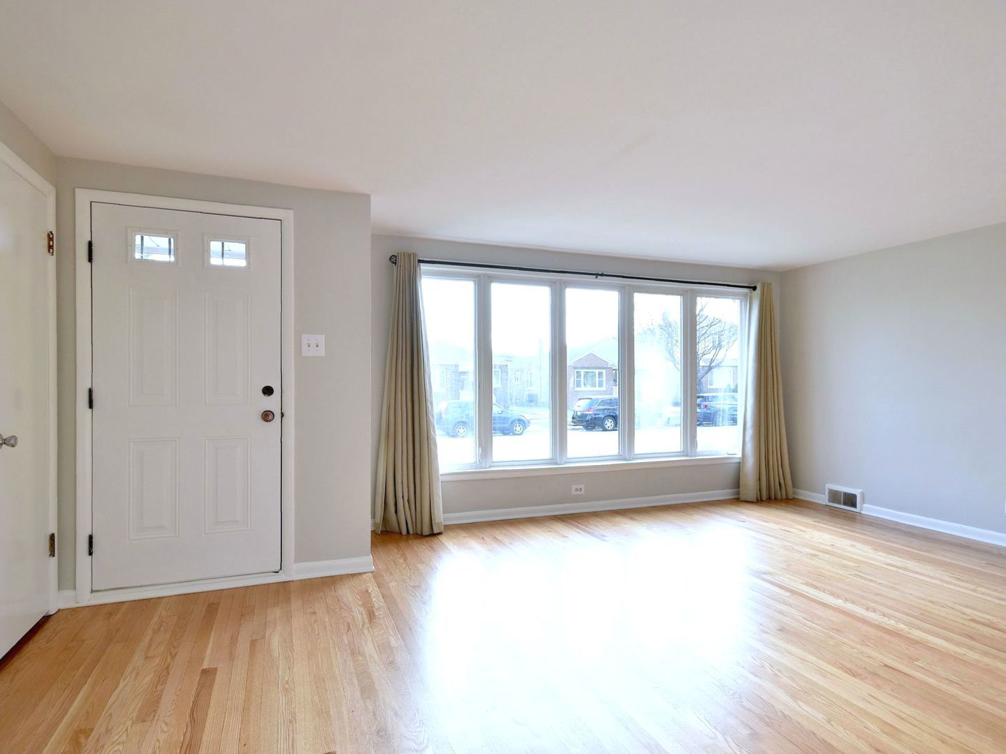 5220 South Rutherford Avenue Chicago, IL 60638 - Photo 3 of 18 a view of empty room with wooden floor and fan