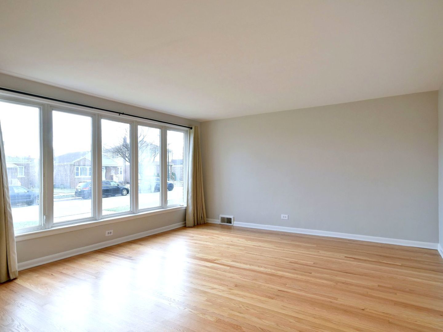 5220 South Rutherford Avenue Chicago, IL 60638 - Photo 4 of 18 a view of an empty room with wooden floor and a window