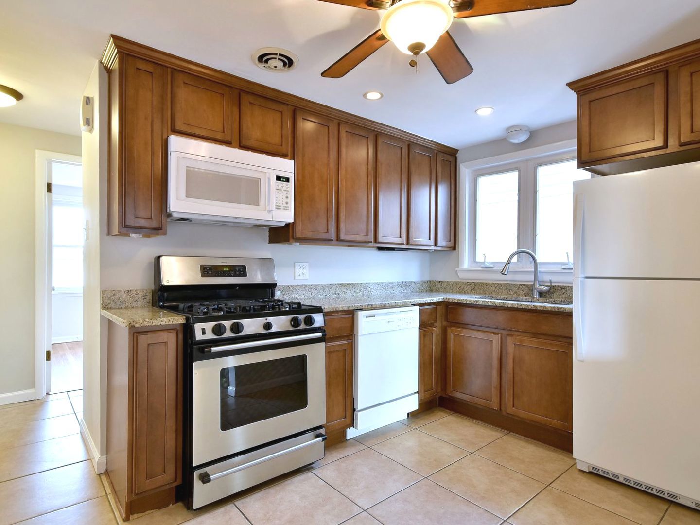 5220 South Rutherford Avenue Chicago, IL 60638 - Photo 7 of 18 a kitchen with stainless steel appliances granite countertop a stove a sink and a microwave