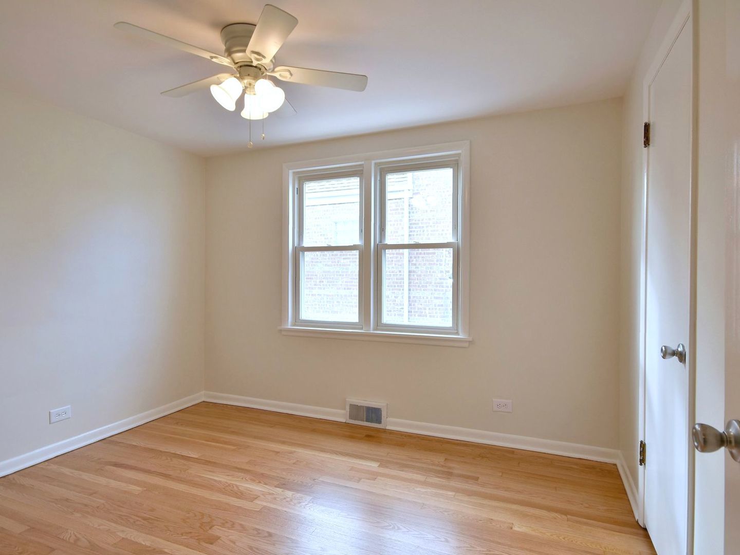 5220 South Rutherford Avenue Chicago, IL 60638 - Photo 10 of 18 a view of empty room with wooden floor and fan