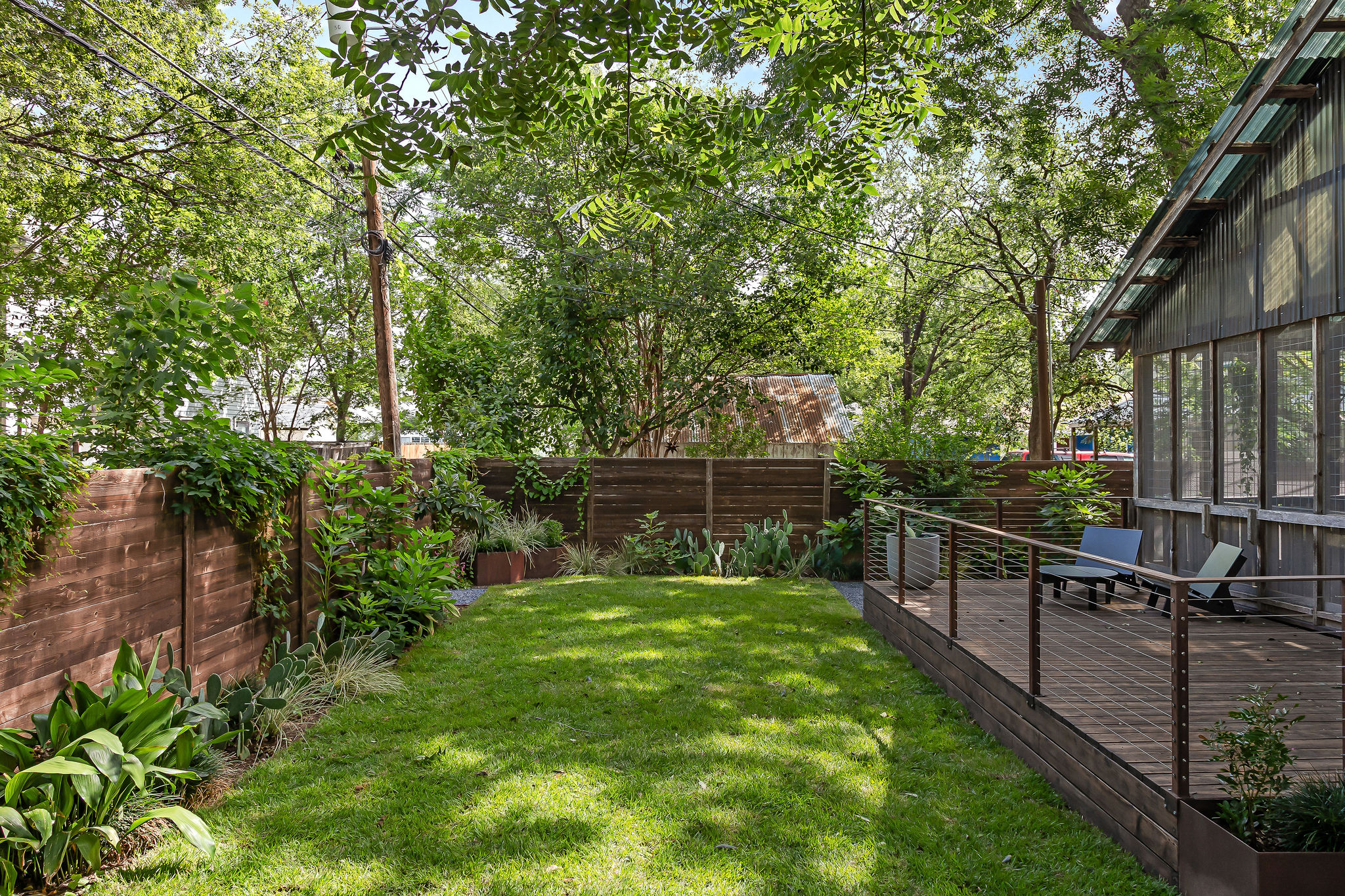 5108 Eilers Avenue Austin, TX 78751 - Photo 7 of 39 Spacious backyard with exterior deck and screened-in porch