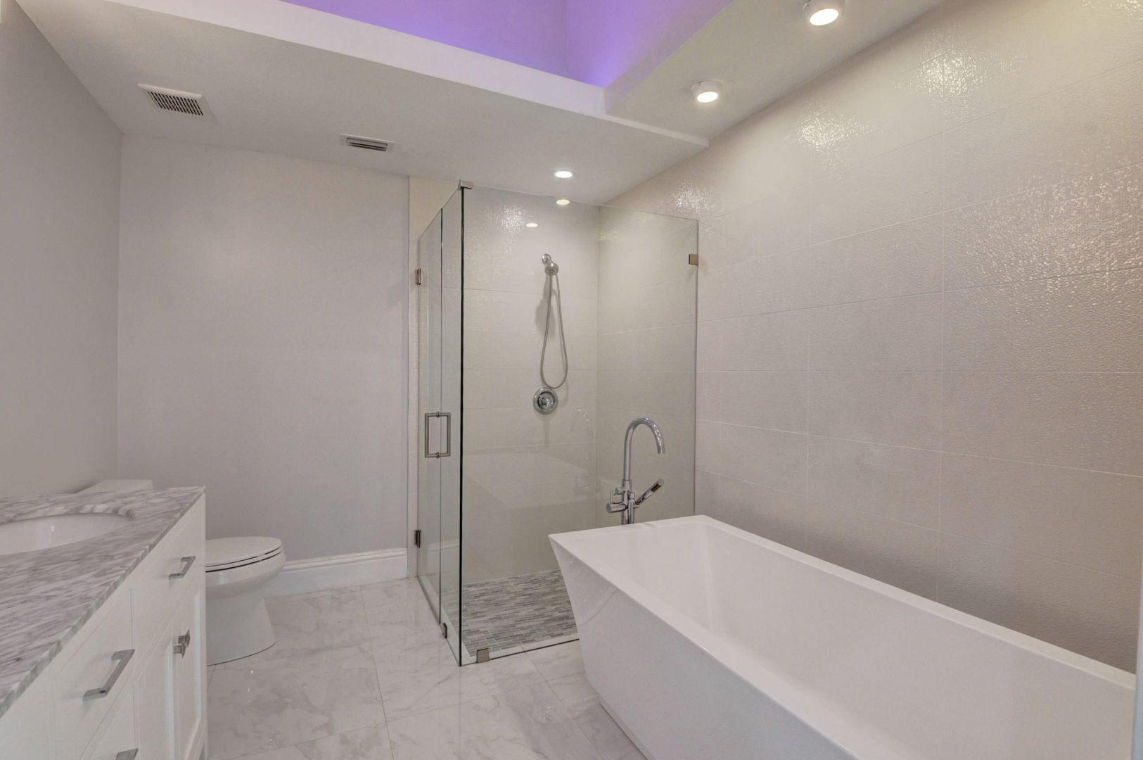 2157 Northwest 52nd Street Boca Raton, FL 33496 - Photo 18 of 27 a bathroom with a granite countertop sink a toilet and bathtub