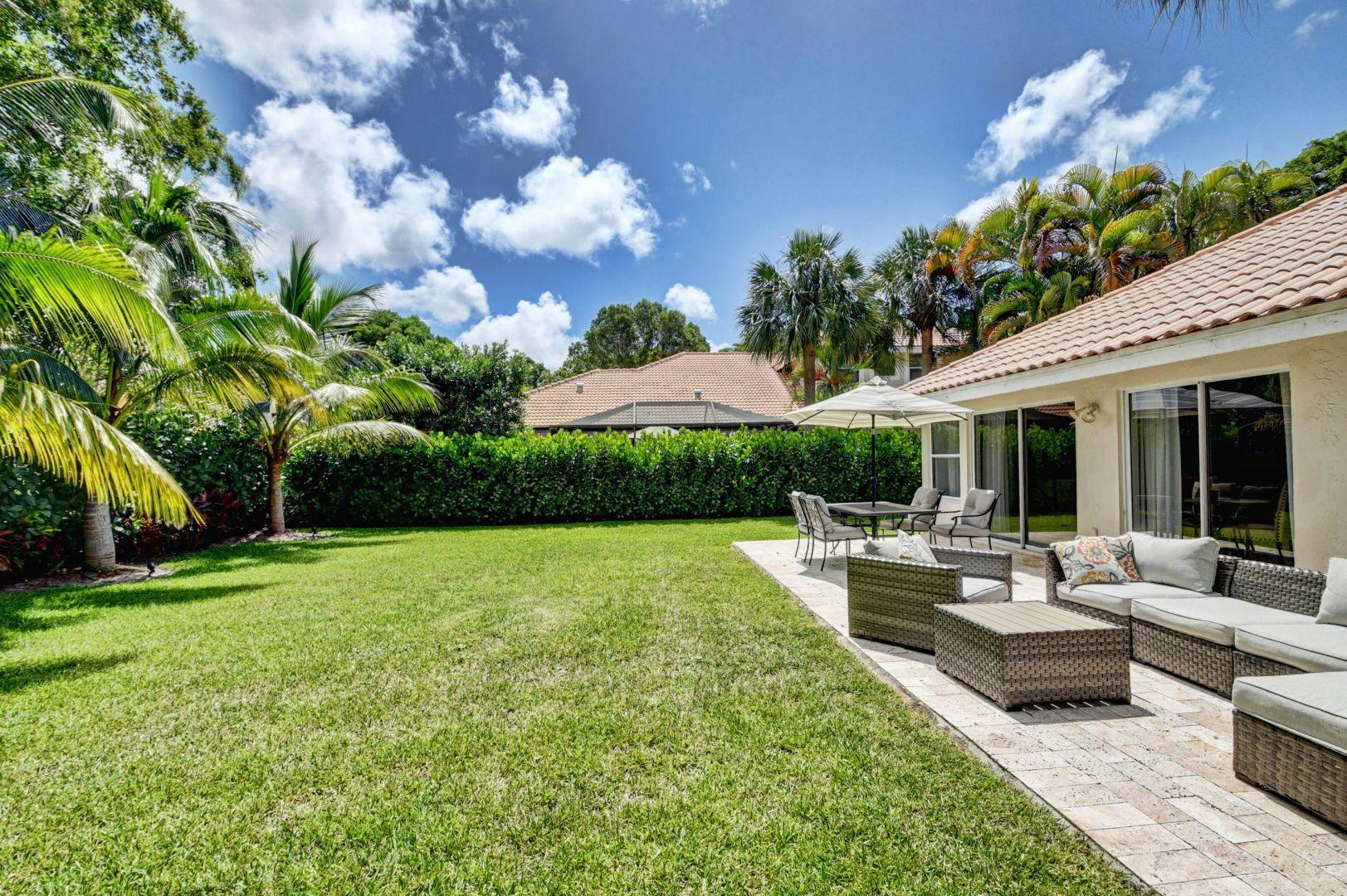 2157 Northwest 52nd Street Boca Raton, FL 33496 - Photo 24 of 27 a view of a patio with couches plants and large trees