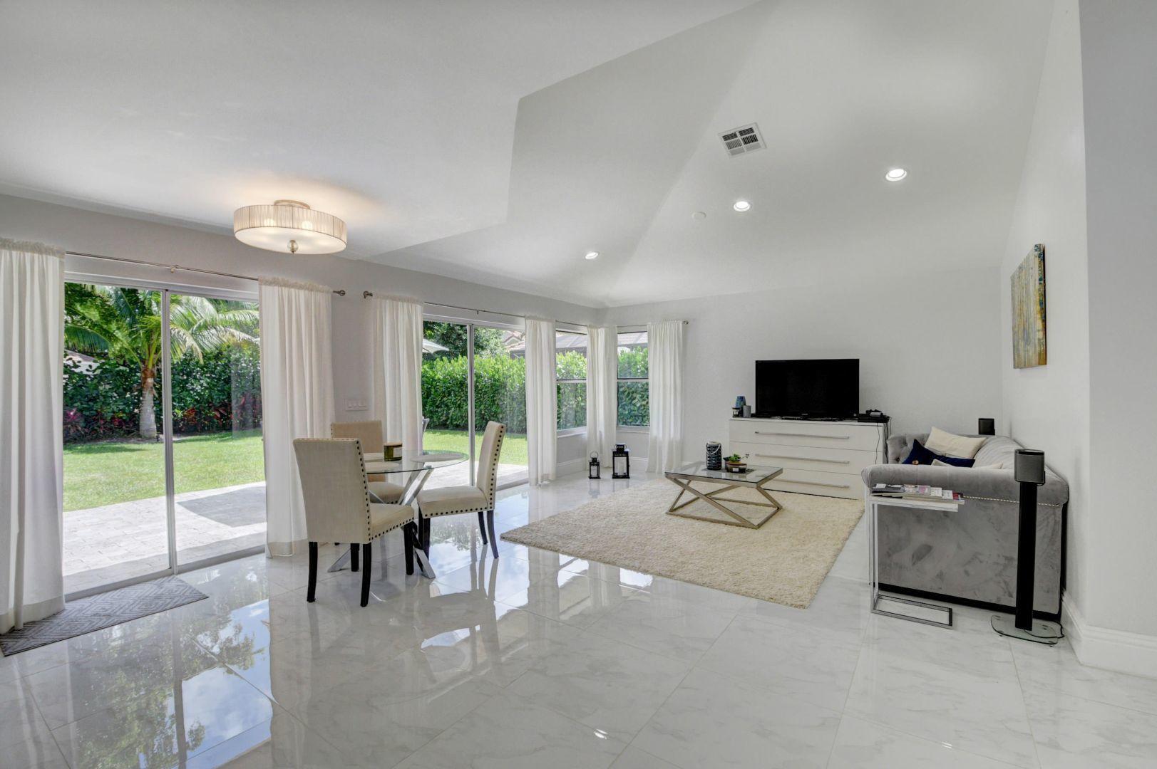 2157 Northwest 52nd Street Boca Raton, FL 33496 - Photo 6 of 27 a living room with furniture tv and large windows