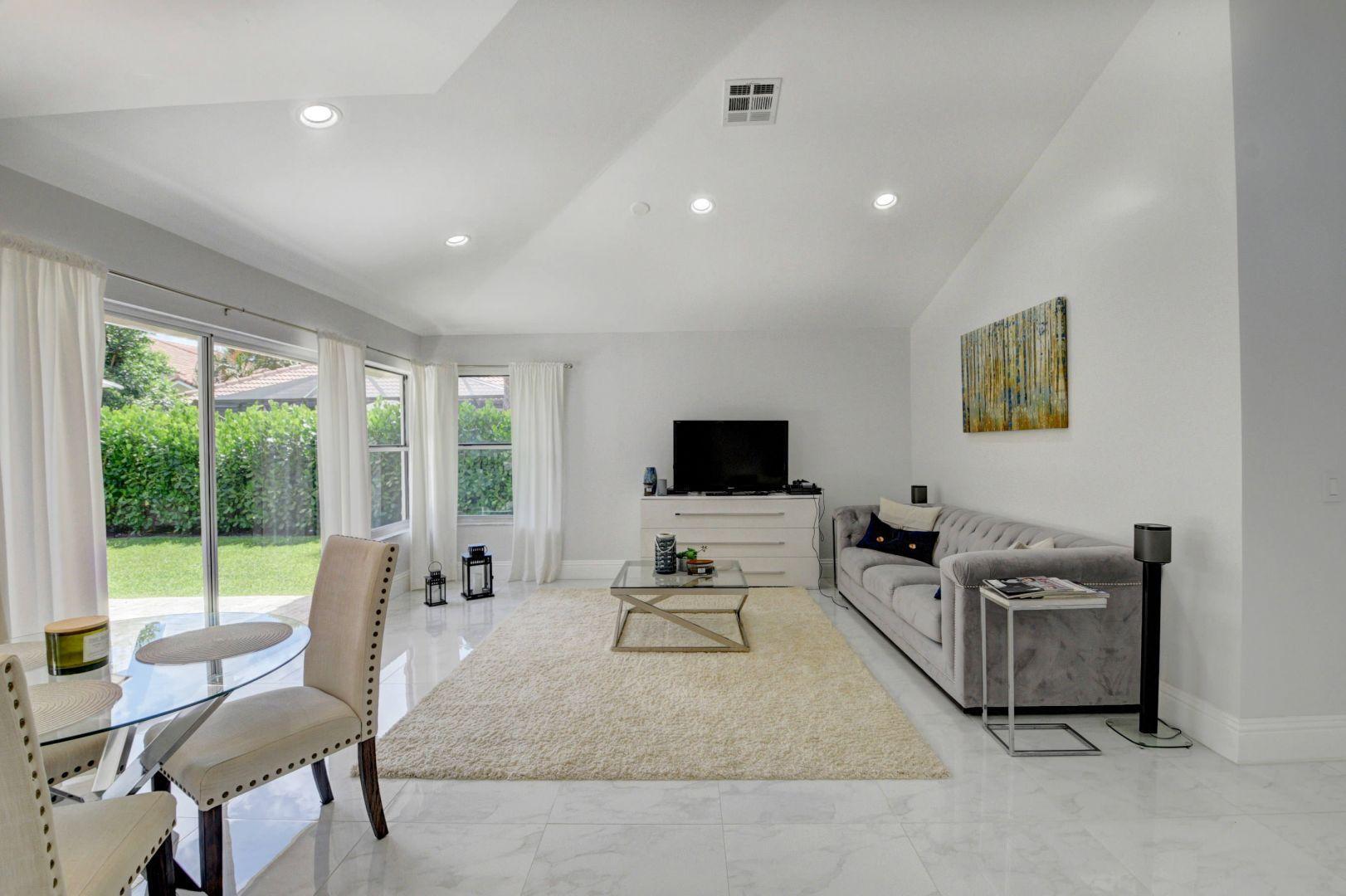 2157 Northwest 52nd Street Boca Raton, FL 33496 - Photo 7 of 27 a living room with furniture and a flat screen tv