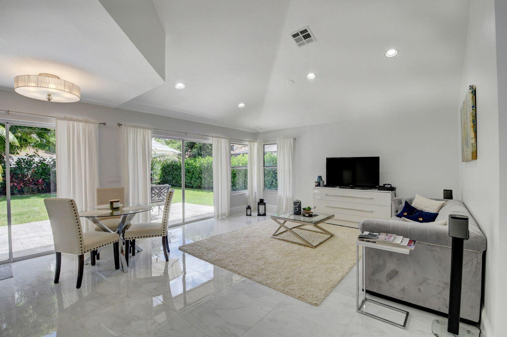 2157 Northwest 52nd Street Boca Raton, FL 33496 - Photo 8 of 27 a living room with furniture and a flat screen tv