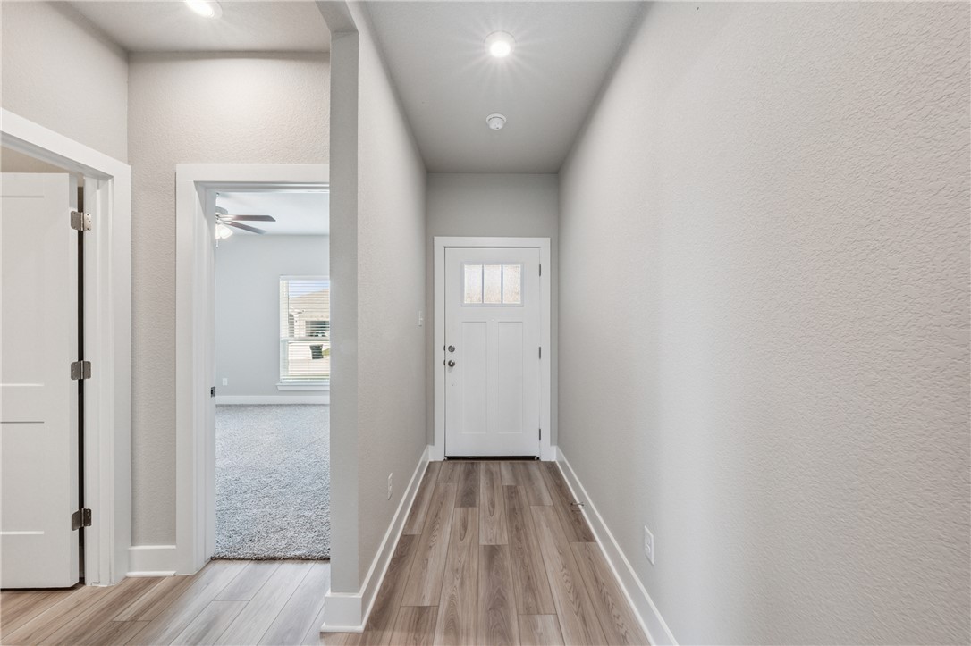 6408 Raleigh Loop College Station, TX 77845 - Photo 8 of 12 Doorway featuring wood finished floors and ceiling fan