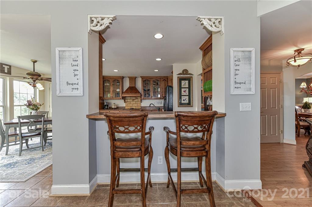 350 Curlee Road Polkton, NC 28135 - Photo 11 of 44 a kitchen with stainless steel appliances kitchen island granite countertop a table and chairs in it