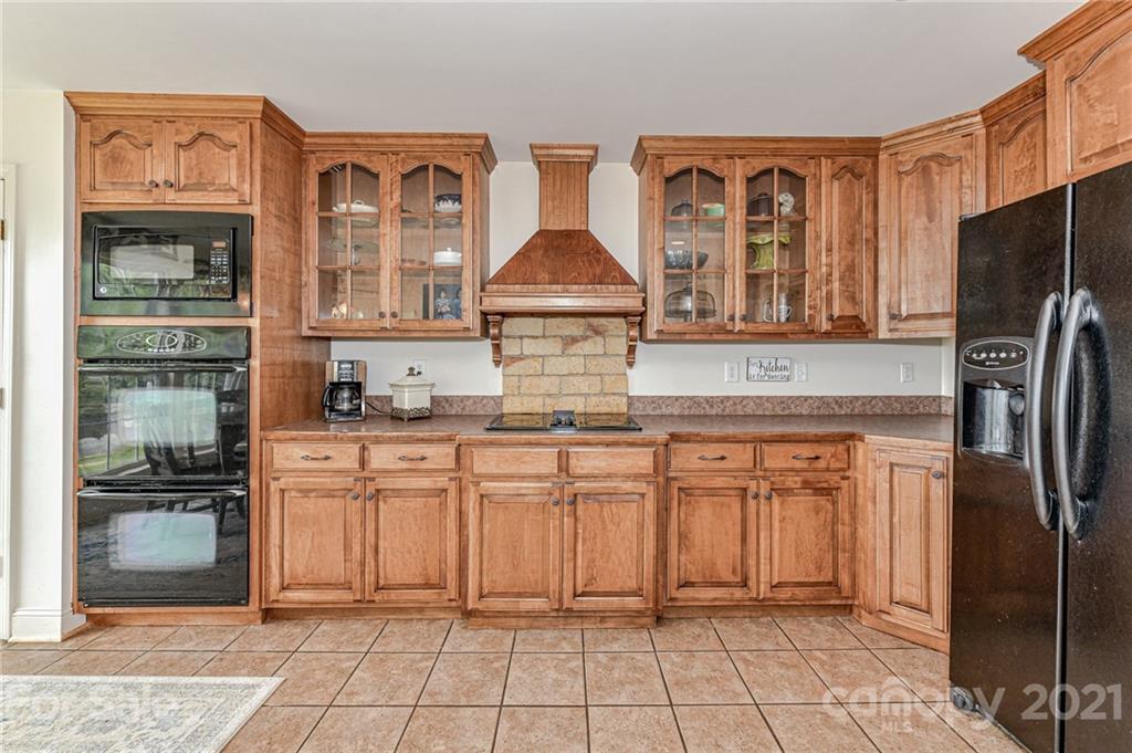 350 Curlee Road Polkton, NC 28135 - Photo 13 of 44 a kitchen with stainless steel appliances granite countertop a refrigerator and a stove top oven