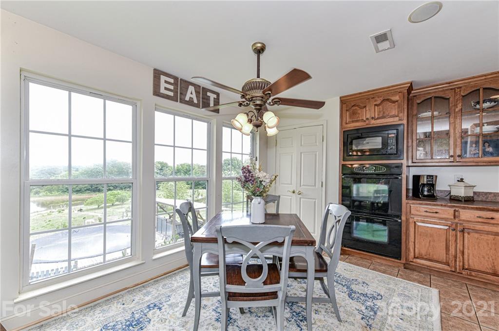 350 Curlee Road Polkton, NC 28135 - Photo 14 of 44 a dining room with furniture a chandelier and wooden floor