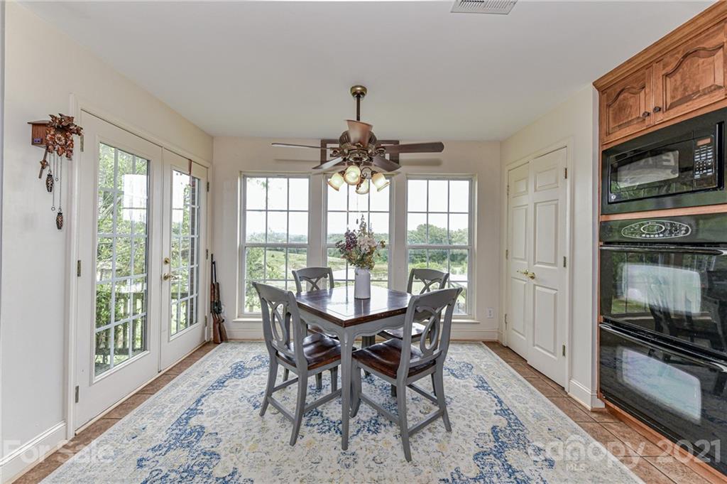350 Curlee Road Polkton, NC 28135 - Photo 15 of 44 a dining room with furniture window and wooden floor