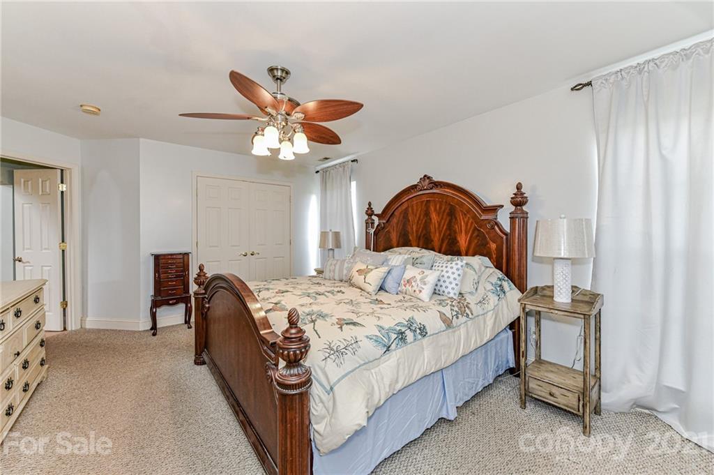 350 Curlee Road Polkton, NC 28135 - Photo 17 of 44 a bedroom with a bed and a chandelier