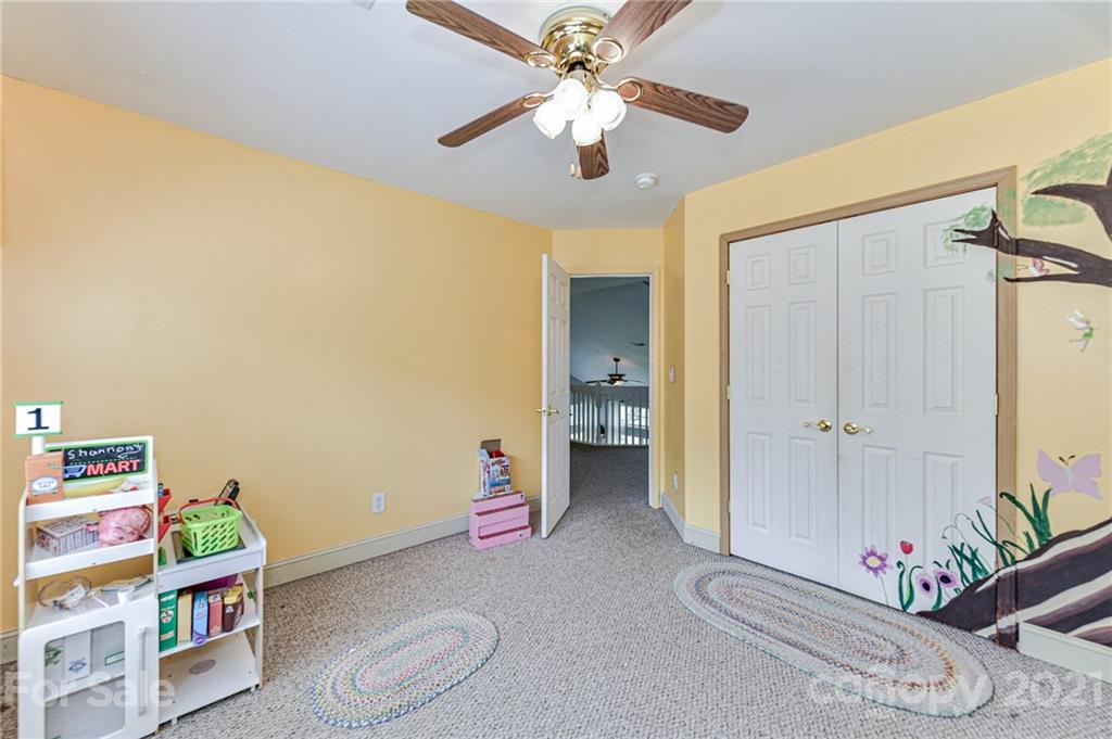 350 Curlee Road Polkton, NC 28135 - Photo 27 of 44 a bedroom with a bed and a chandelier