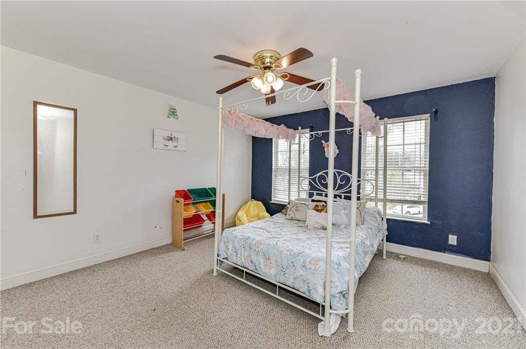 350 Curlee Road Polkton, NC 28135 - Photo 29 of 44 a bed room with a bed and a chandelier
