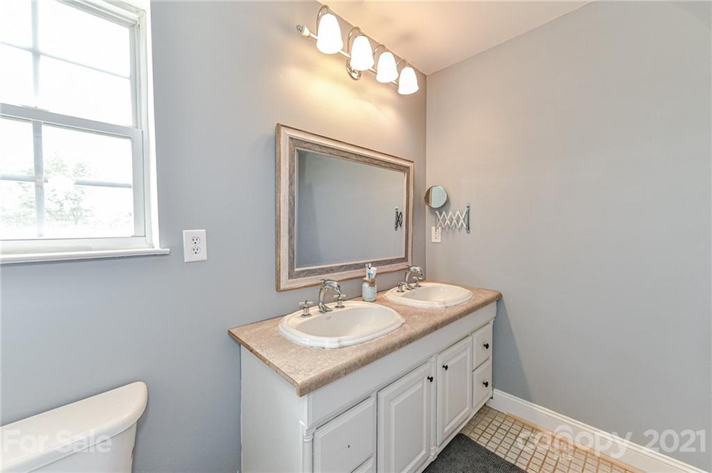 350 Curlee Road Polkton, NC 28135 - Photo 31 of 44 a bathroom with a sink a vanity and a mirror