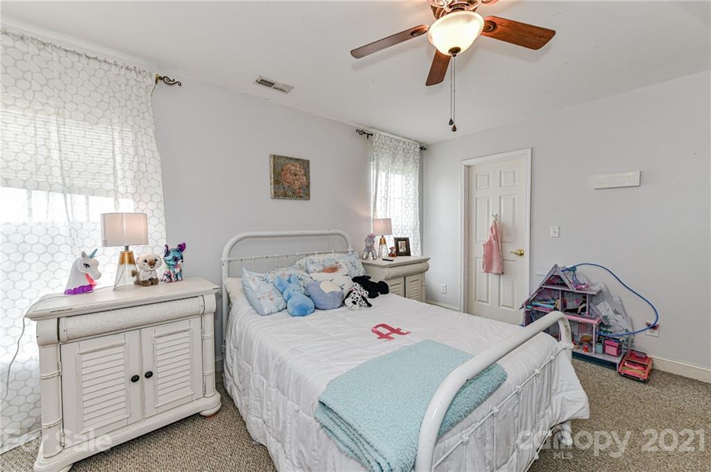 350 Curlee Road Polkton, NC 28135 - Photo 34 of 44 a bedroom with a bed and a chandelier