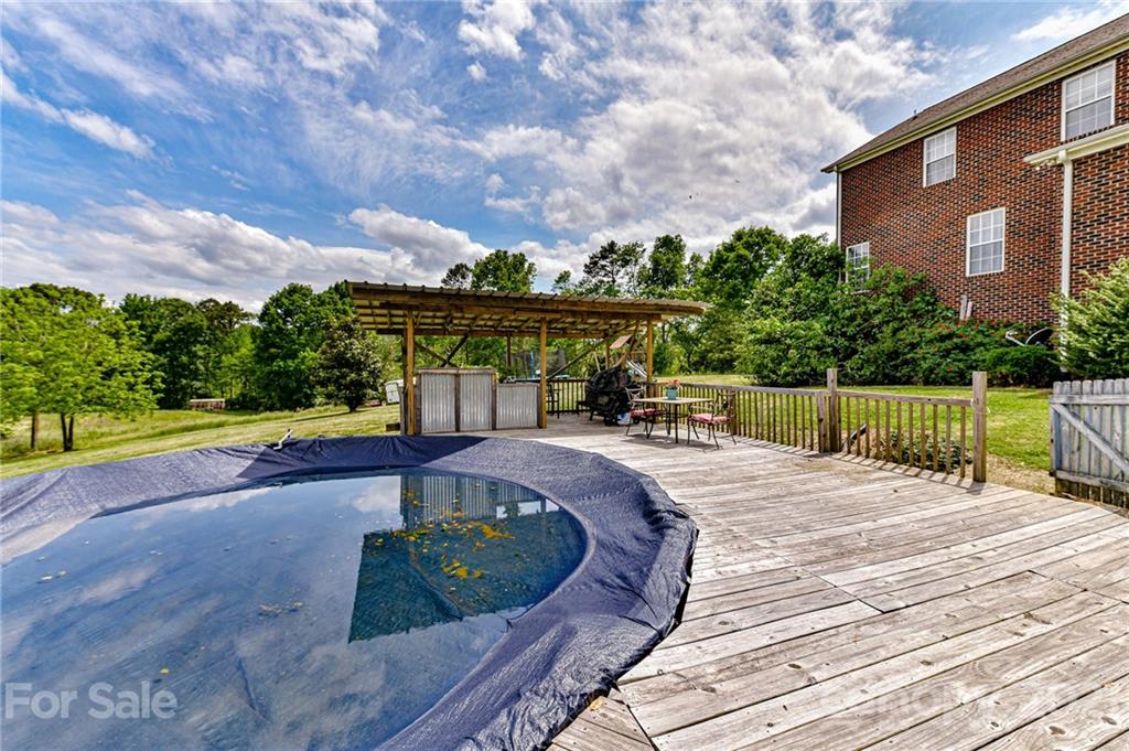 350 Curlee Road Polkton, NC 28135 - Photo 37 of 44 a view of a swimming pool with a patio