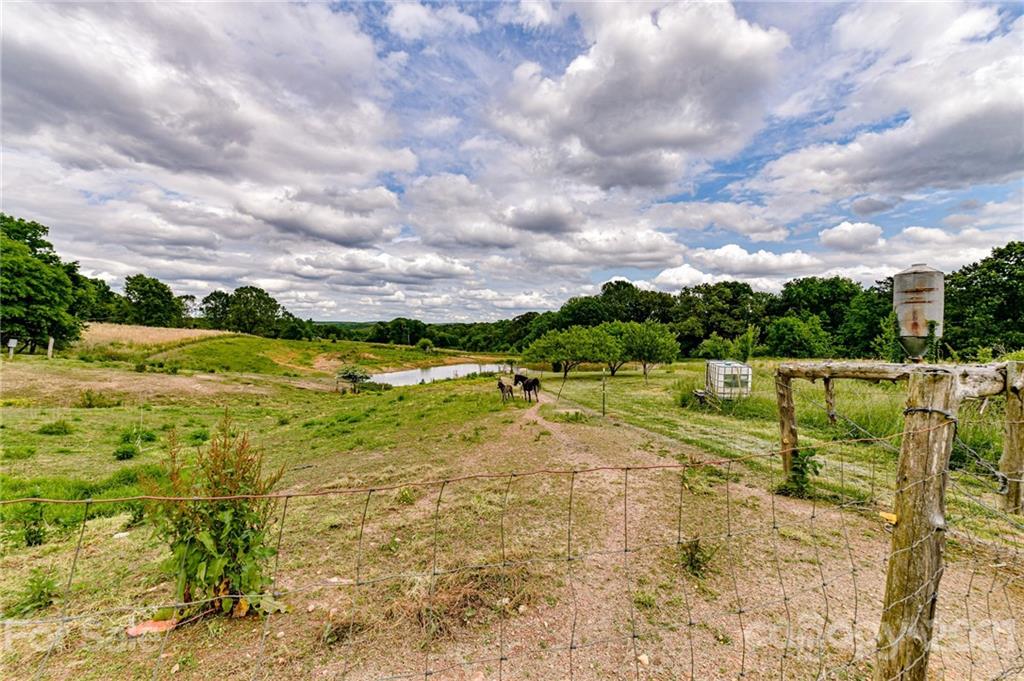 350 Curlee Road Polkton, NC 28135 - Photo 40 of 44 a view of a yard with swimming pool and mountains