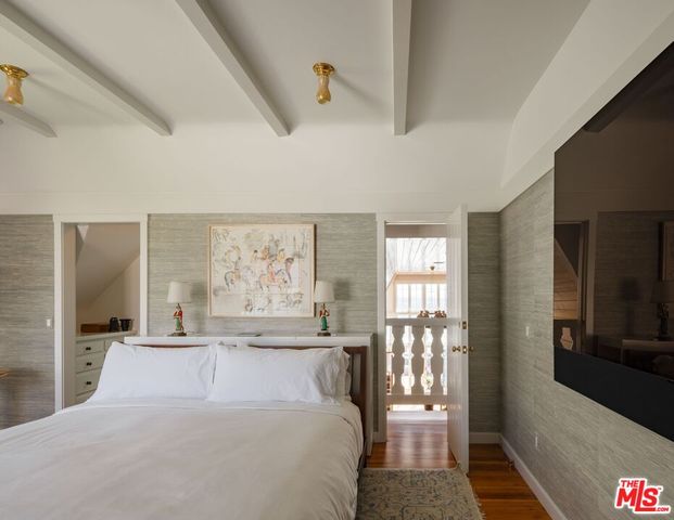 a bedroom with a large bed and a large window