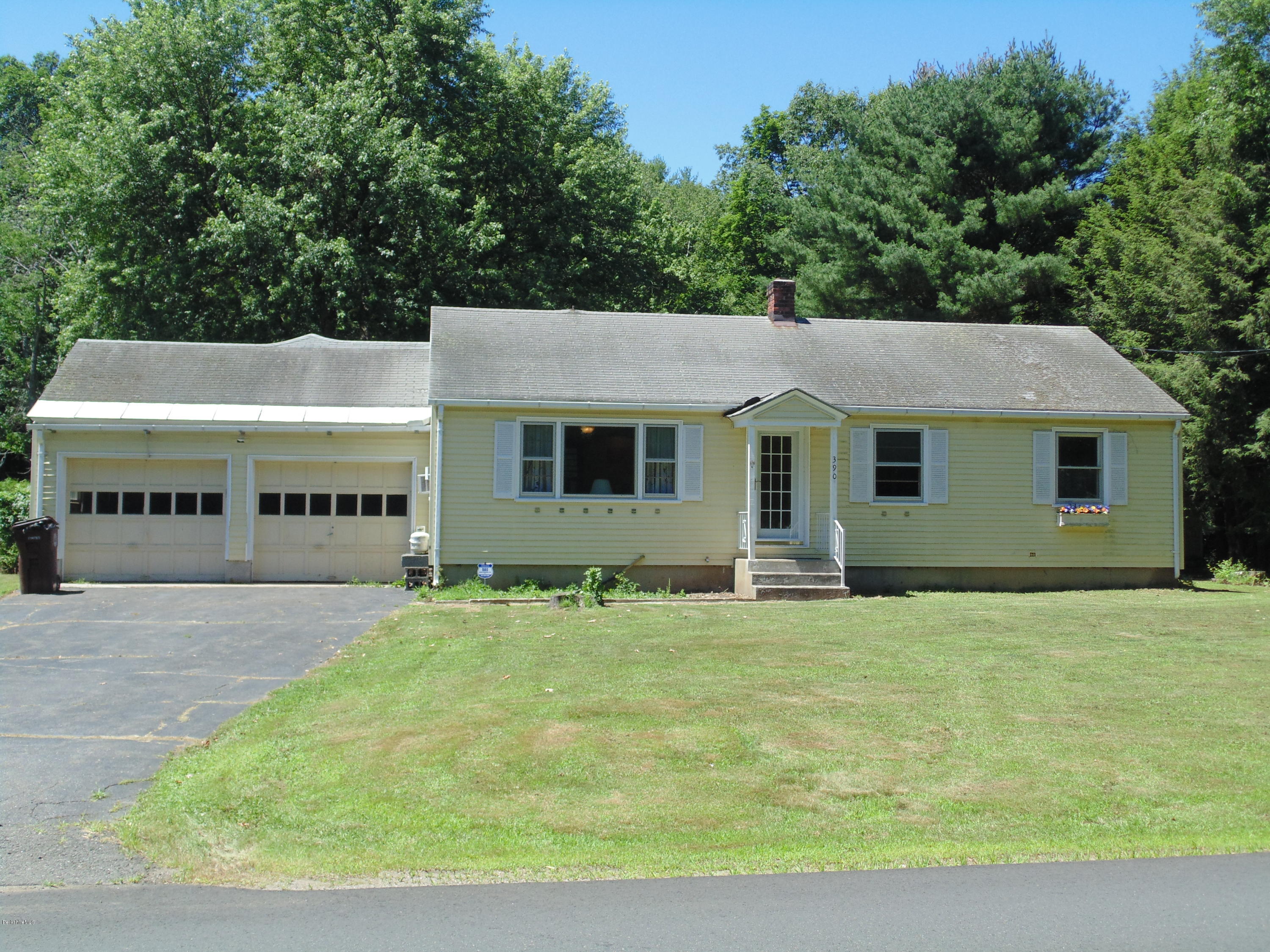 390 Montgomery Road Westfield, MA 01085 - Photo 1 of 29 a front view of a house with a garden