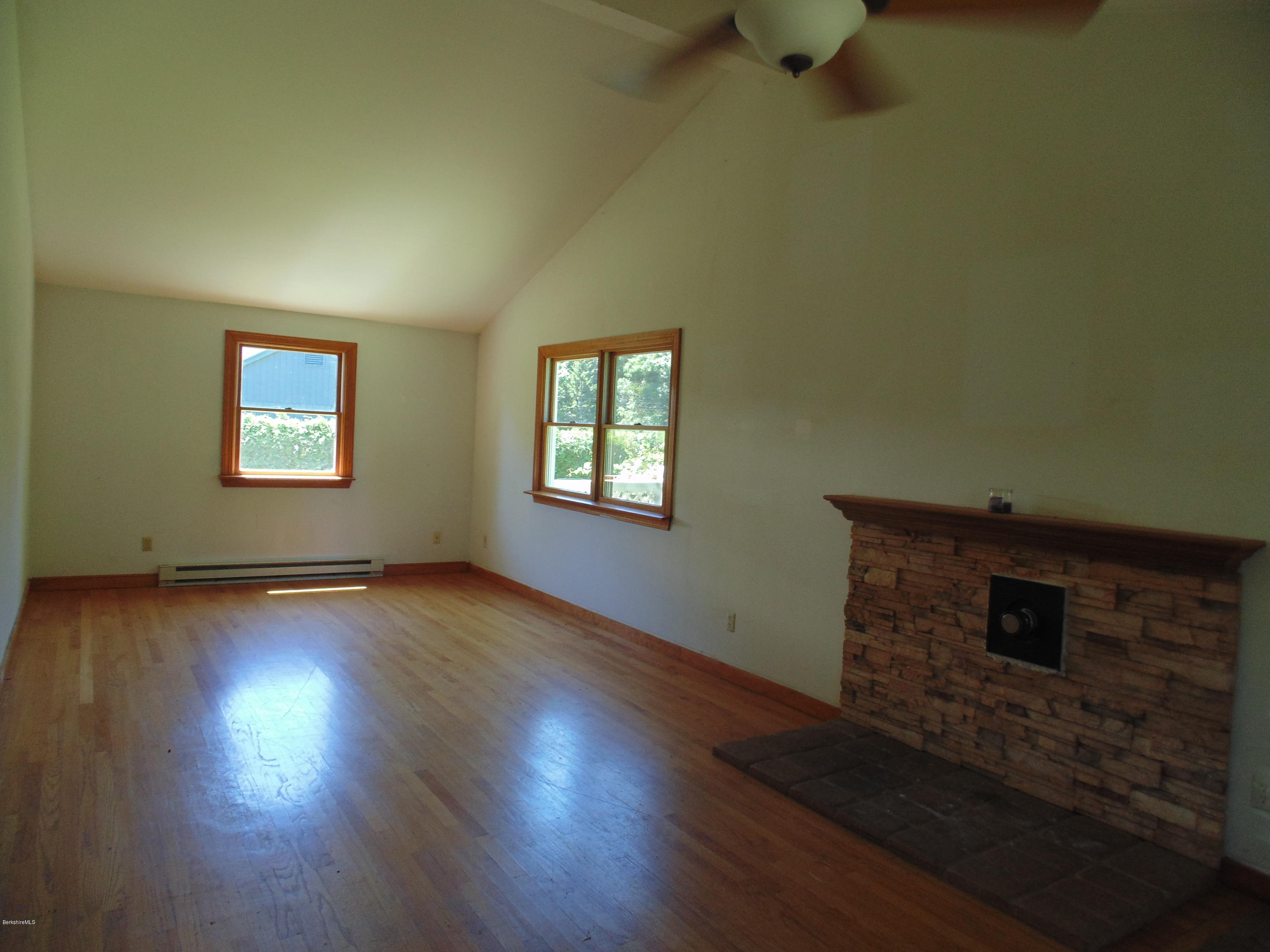 390 Montgomery Road Westfield, MA 01085 - Photo 2 of 29 a view of an empty room with wooden floor and a window