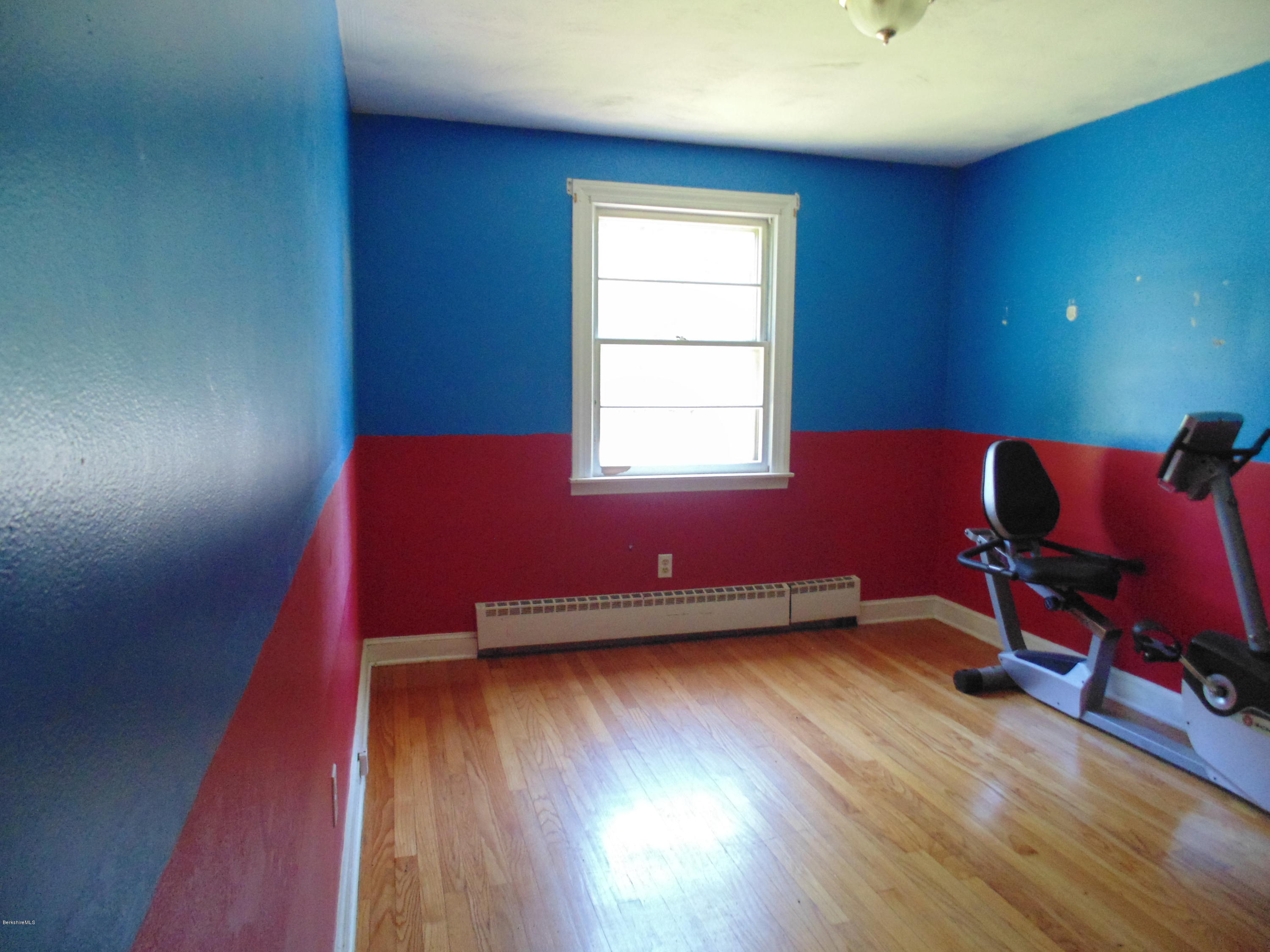 390 Montgomery Road Westfield, MA 01085 - Photo 12 of 29 a room with chair and wooden floor