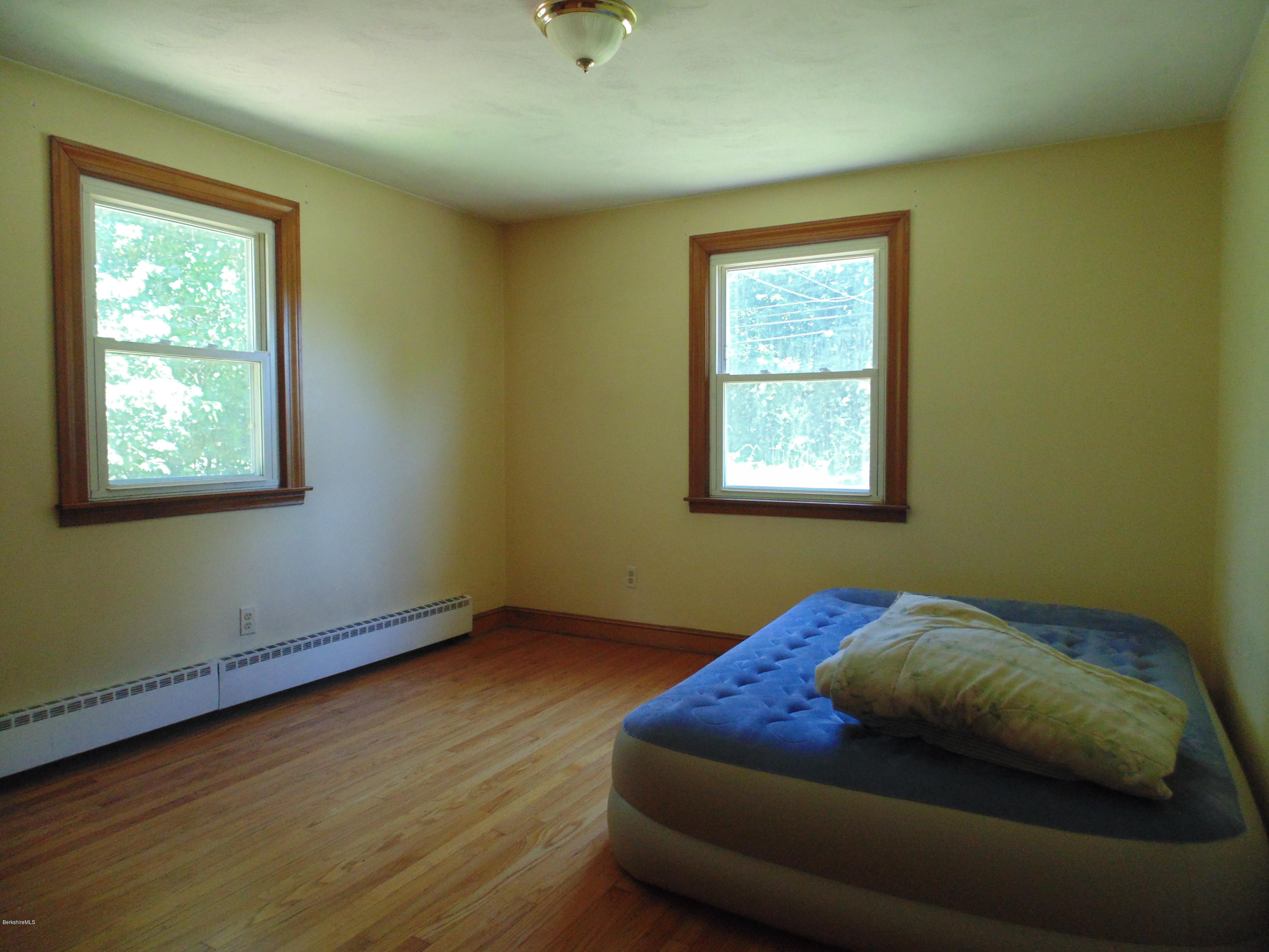 390 Montgomery Road Westfield, MA 01085 - Photo 14 of 29 a bed sitting in a bedroom next to a window