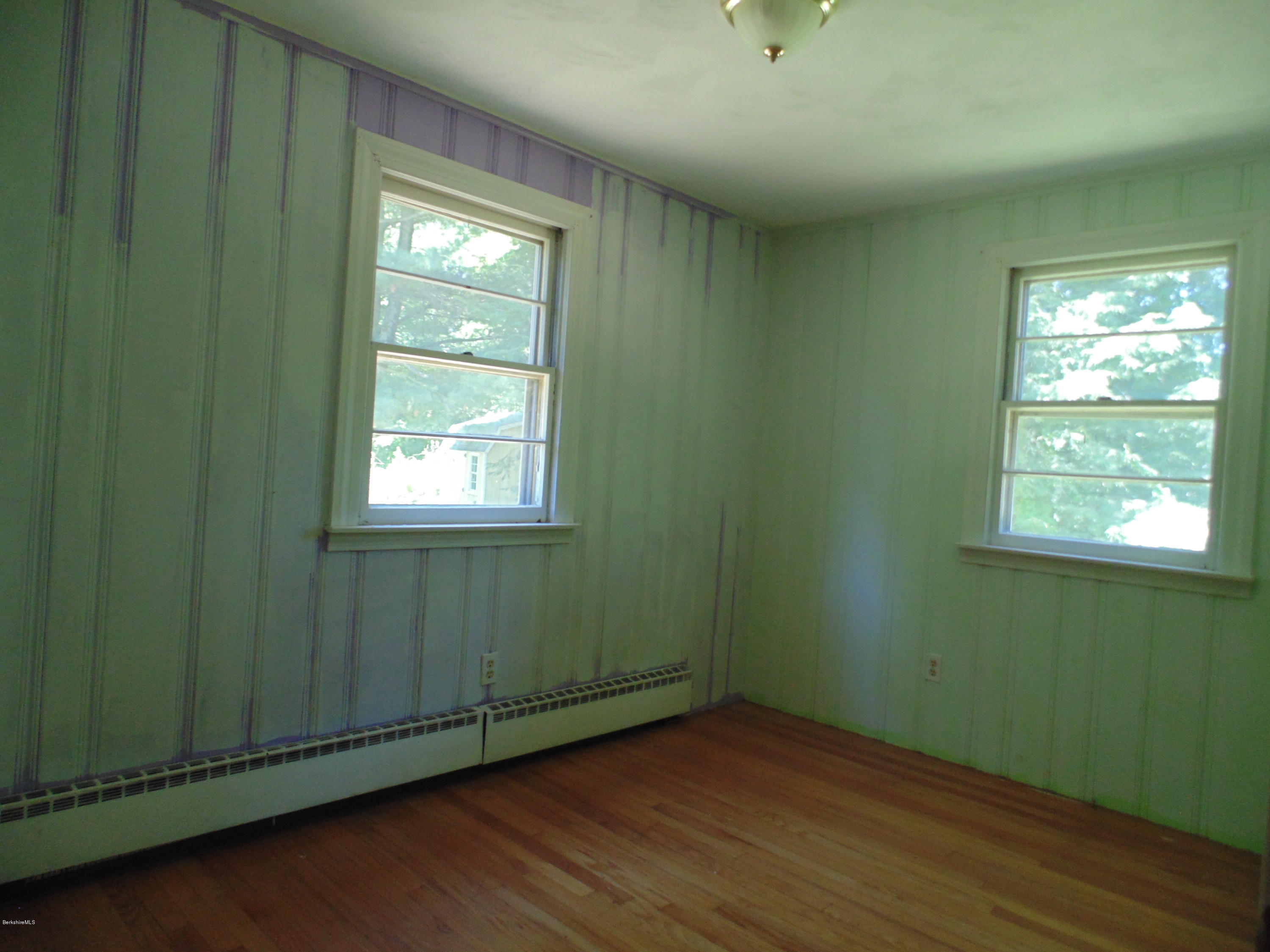 390 Montgomery Road Westfield, MA 01085 - Photo 16 of 29 an empty room with wooden floor closet and windows