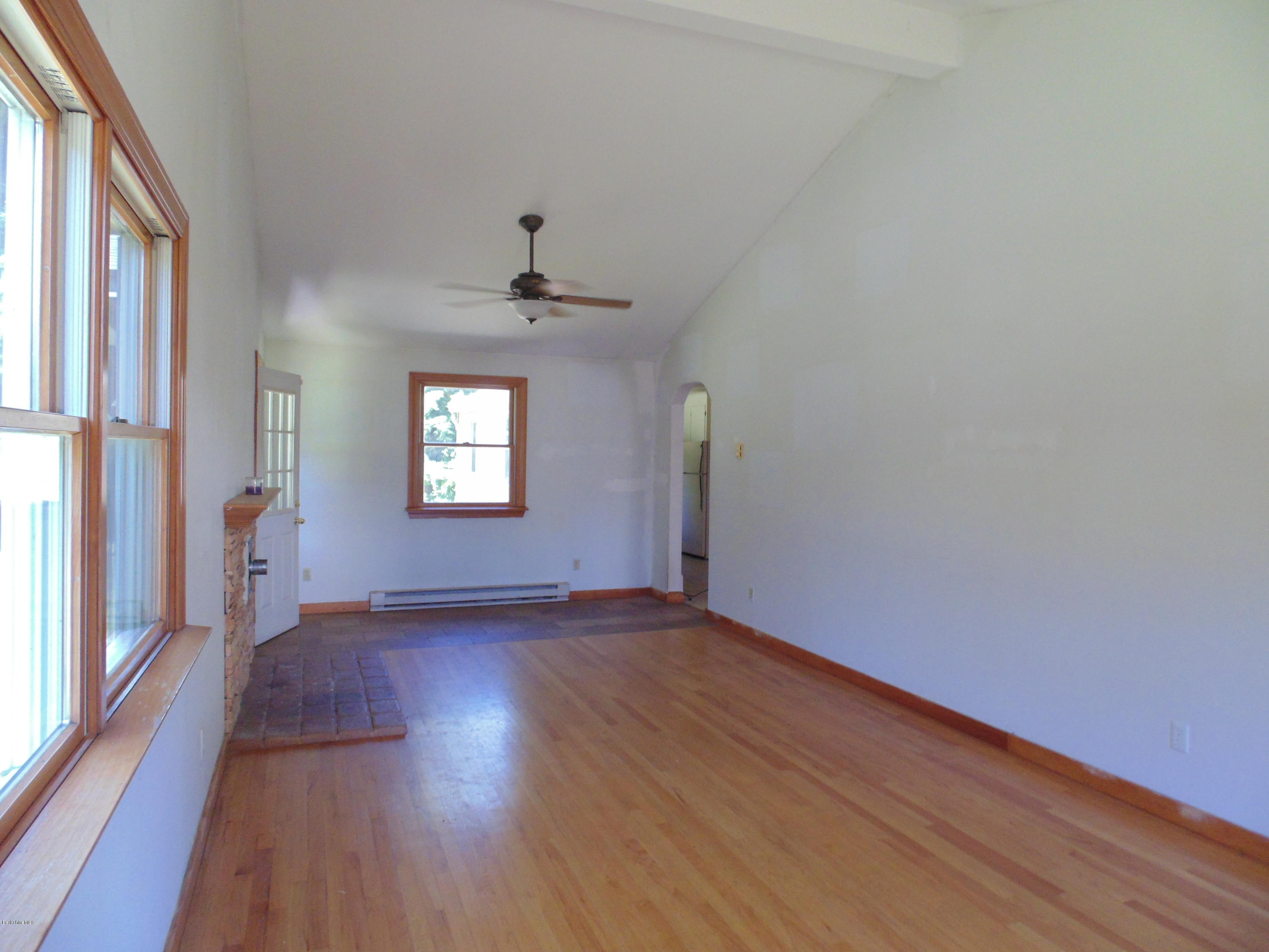 390 Montgomery Road Westfield, MA 01085 - Photo 3 of 29 a view of an empty room with wooden floor and a window