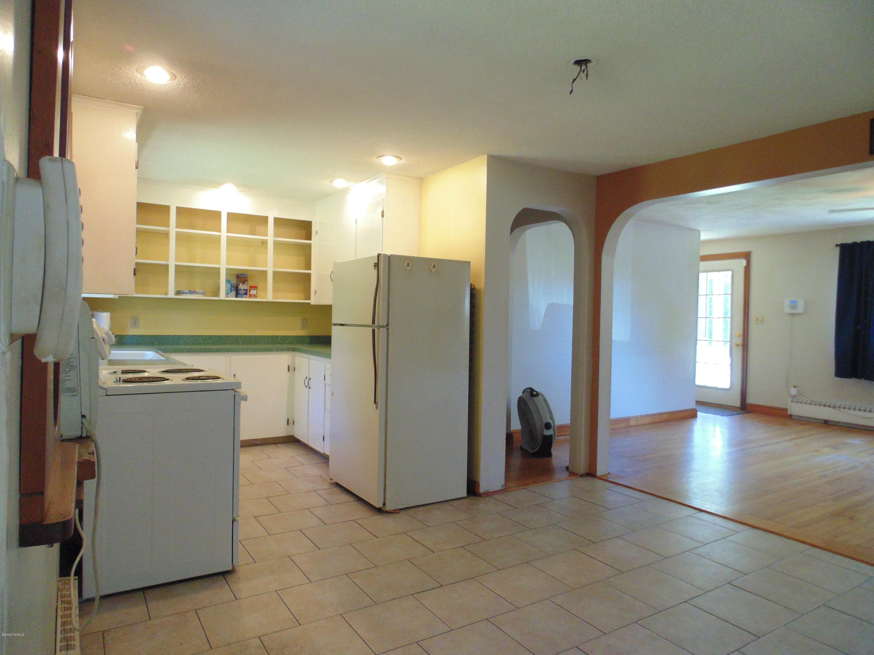 390 Montgomery Road Westfield, MA 01085 - Photo 5 of 29 a view of a kitchen with a refrigerator and a sink