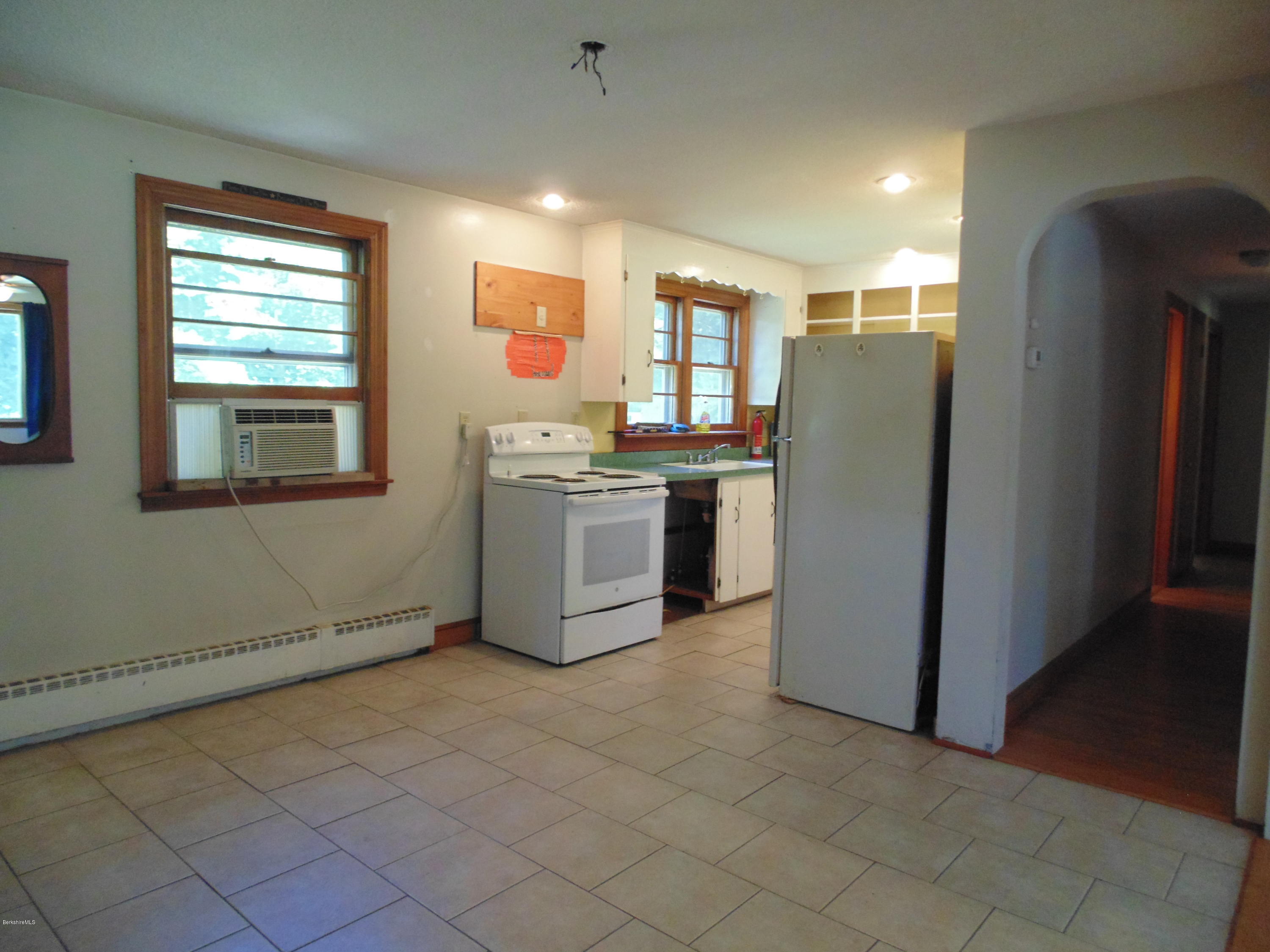 390 Montgomery Road Westfield, MA 01085 - Photo 8 of 29 a view of a kitchen with fridge and wooden floor