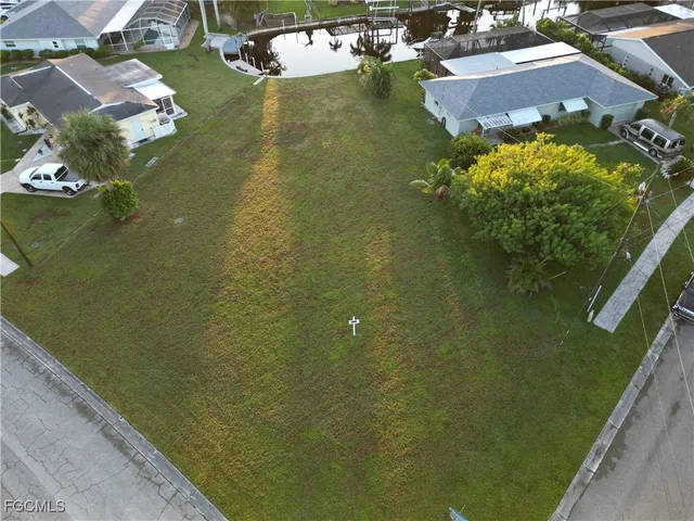 an aerial view of a house with a yard