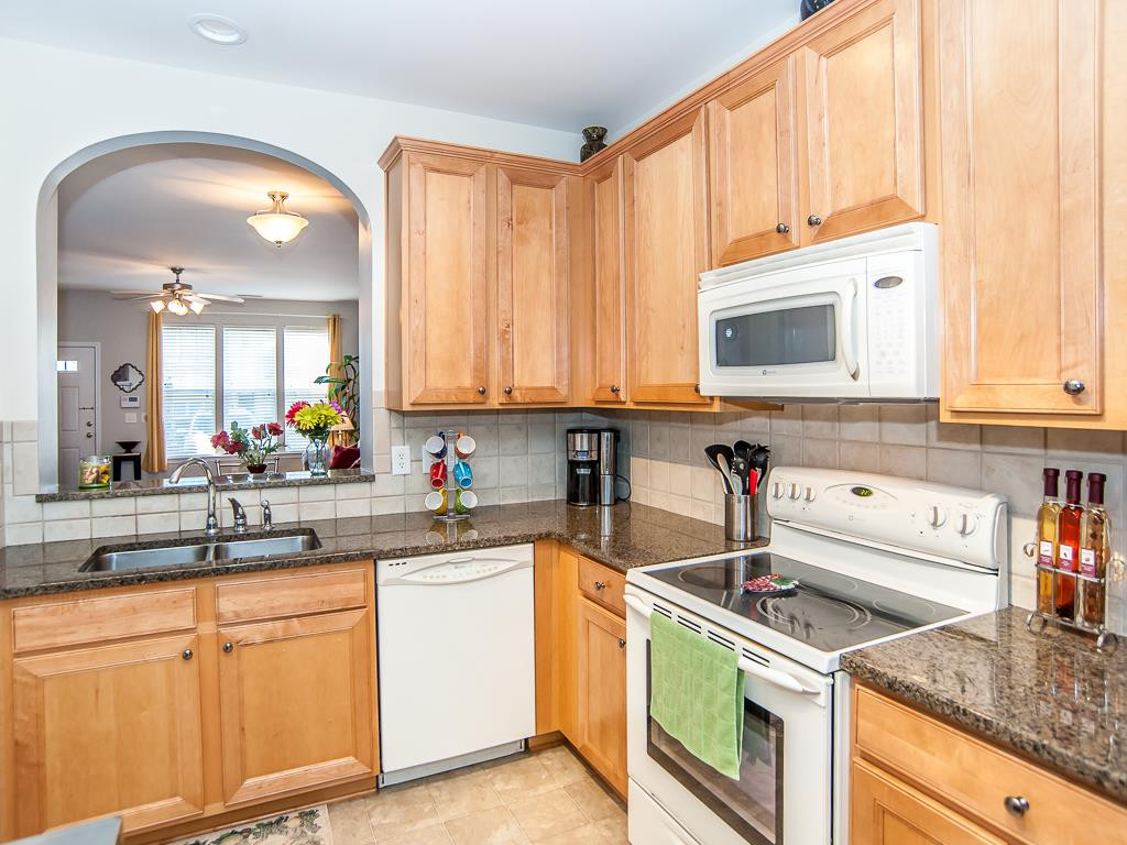 4815 Sir Duncan Way Raleigh, NC 27612 - Photo 13 of 25 Granite countertops and an upgraded Stainless Steel Refrigerator that conveys with the property. Kitchen