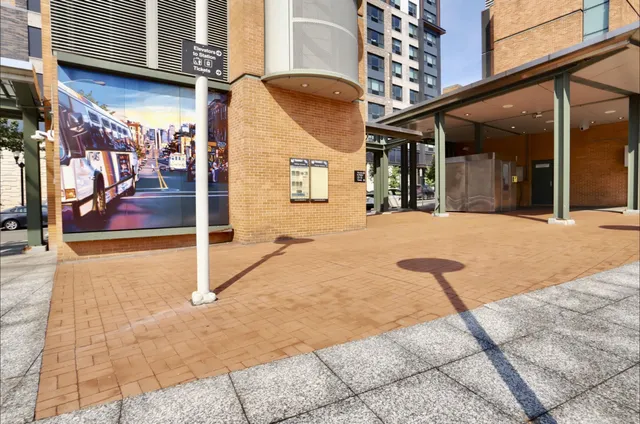 a view of a brick building next to a yard