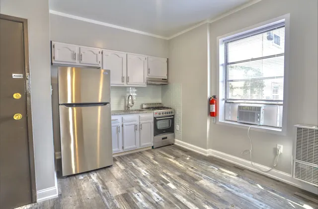 a kitchen with a refrigerator a stove a microwave and cabinets