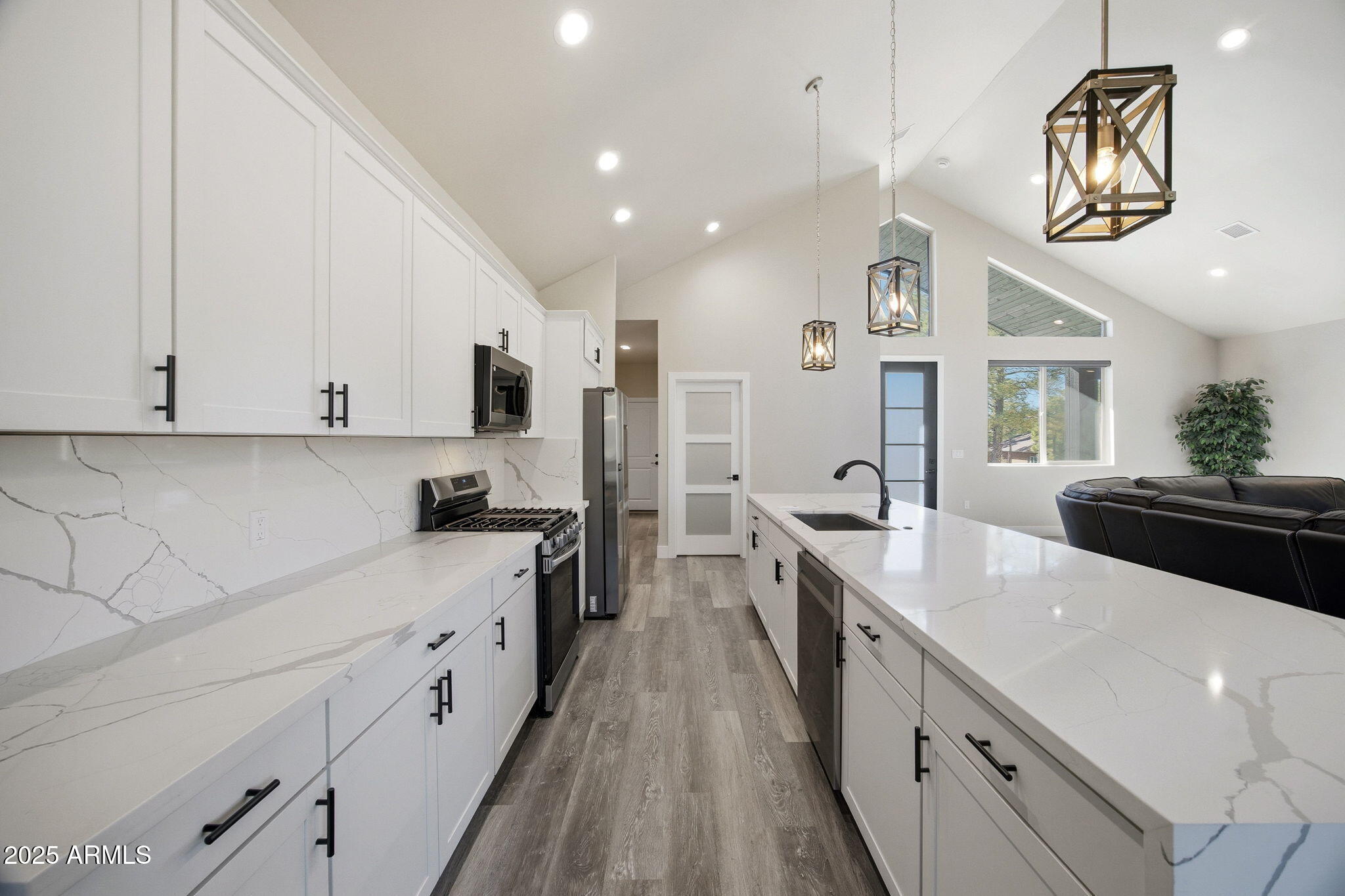 2701 North Eagle View Circle Show Low, AZ 85901 - Photo 10 of 49 a large kitchen with stainless steel appliances a large counter top a stove a chimney a sink and dishwasher