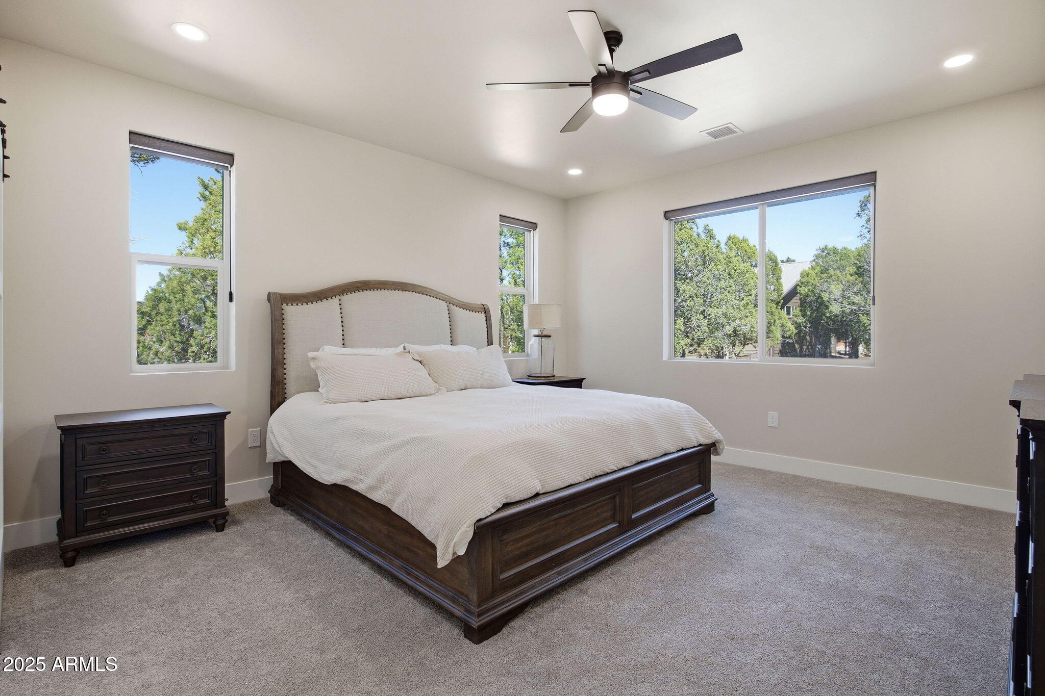 2701 North Eagle View Circle Show Low, AZ 85901 - Photo 13 of 49 a bed sitting in a spacious bedroom next to a window