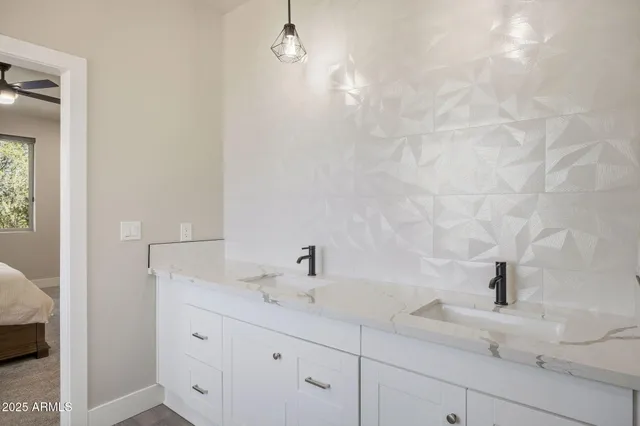 a bedroom with a bed and a ceiling fan