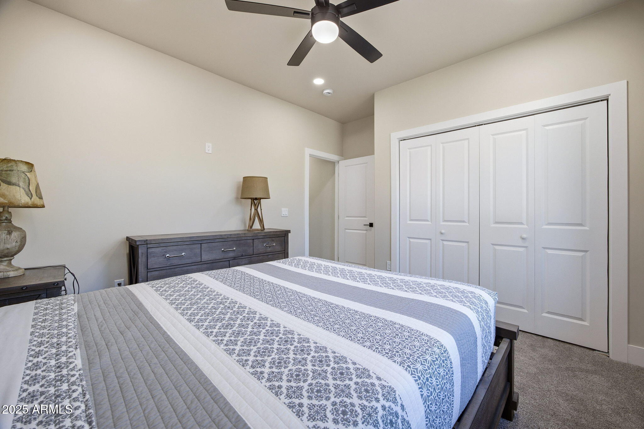2701 North Eagle View Circle Show Low, AZ 85901 - Photo 23 of 49 a bedroom with a large bed and a chandelier