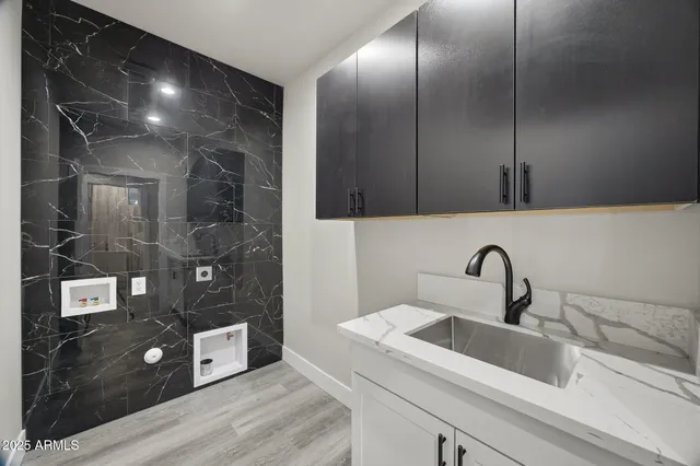 a white toilet sitting next to a white sink