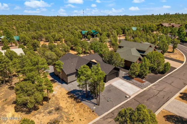 aerial view of a house with a yard and sitting area