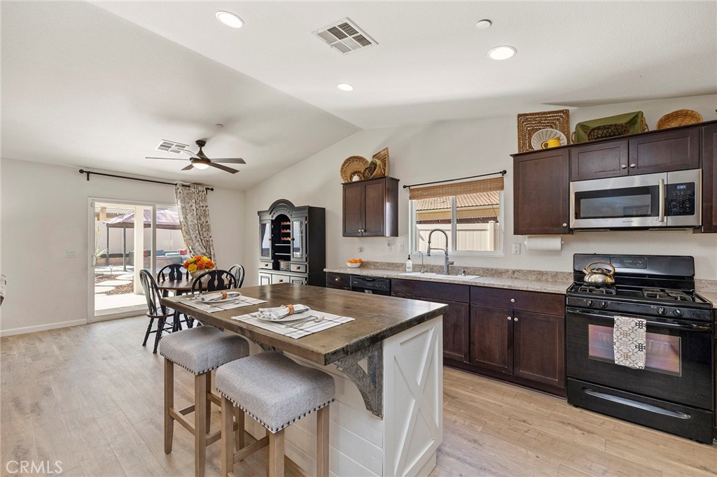 33185 Big Range Drive Winchester, CA 92596 - Photo 17 of 54 a large kitchen with a table and chairs in it