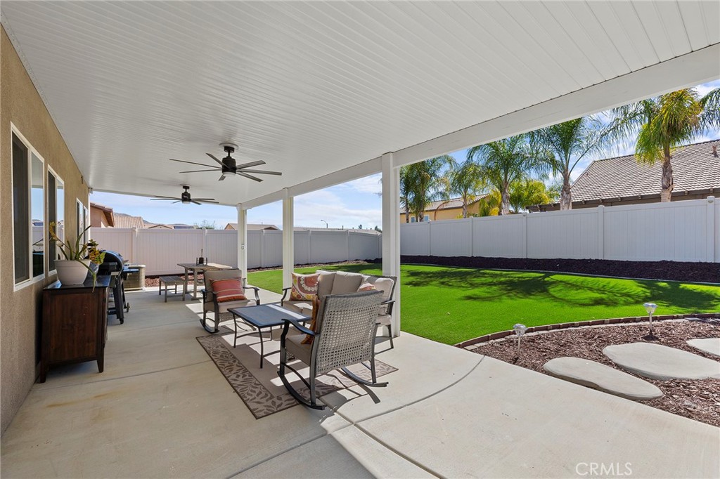 33185 Big Range Drive Winchester, CA 92596 - Photo 43 of 54 a view of a patio with a dining table and chairs under an umbrella