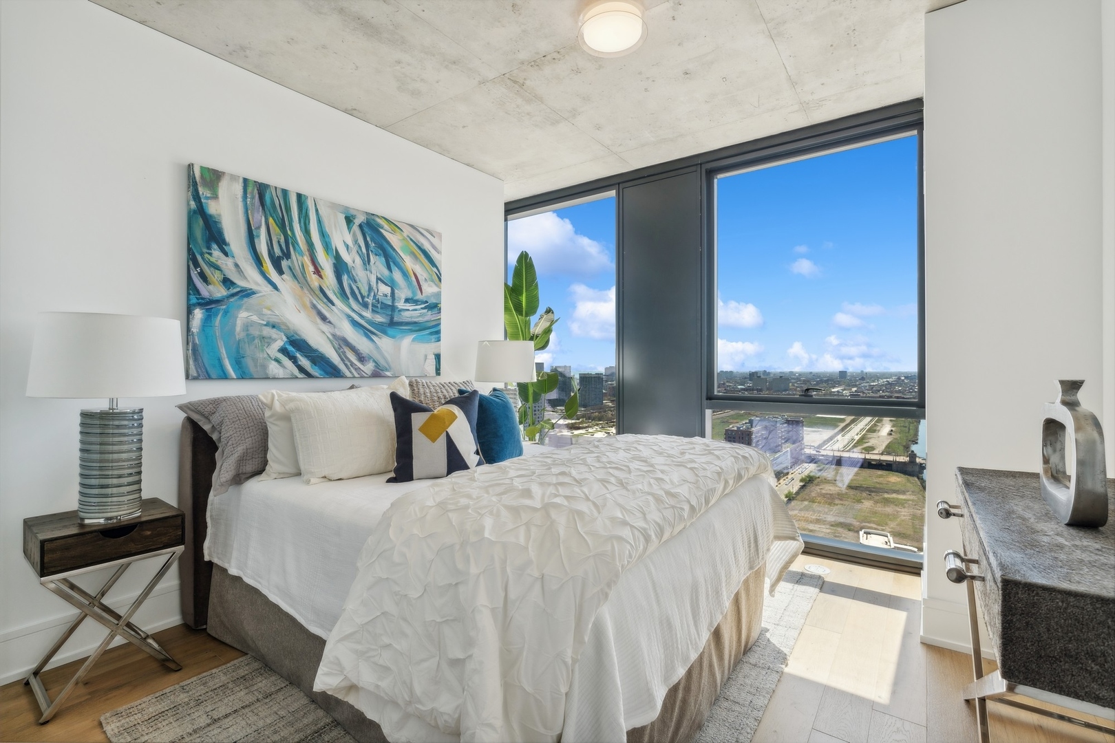 234 West Polk Street, Unit 3307 Chicago, IL 60607 - Photo 11 of 31 a bedroom with a large bed and a chandelier