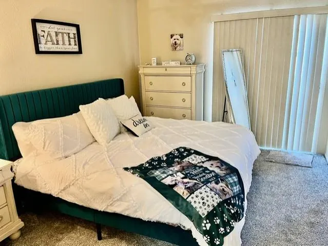 a bedroom with a bed and window